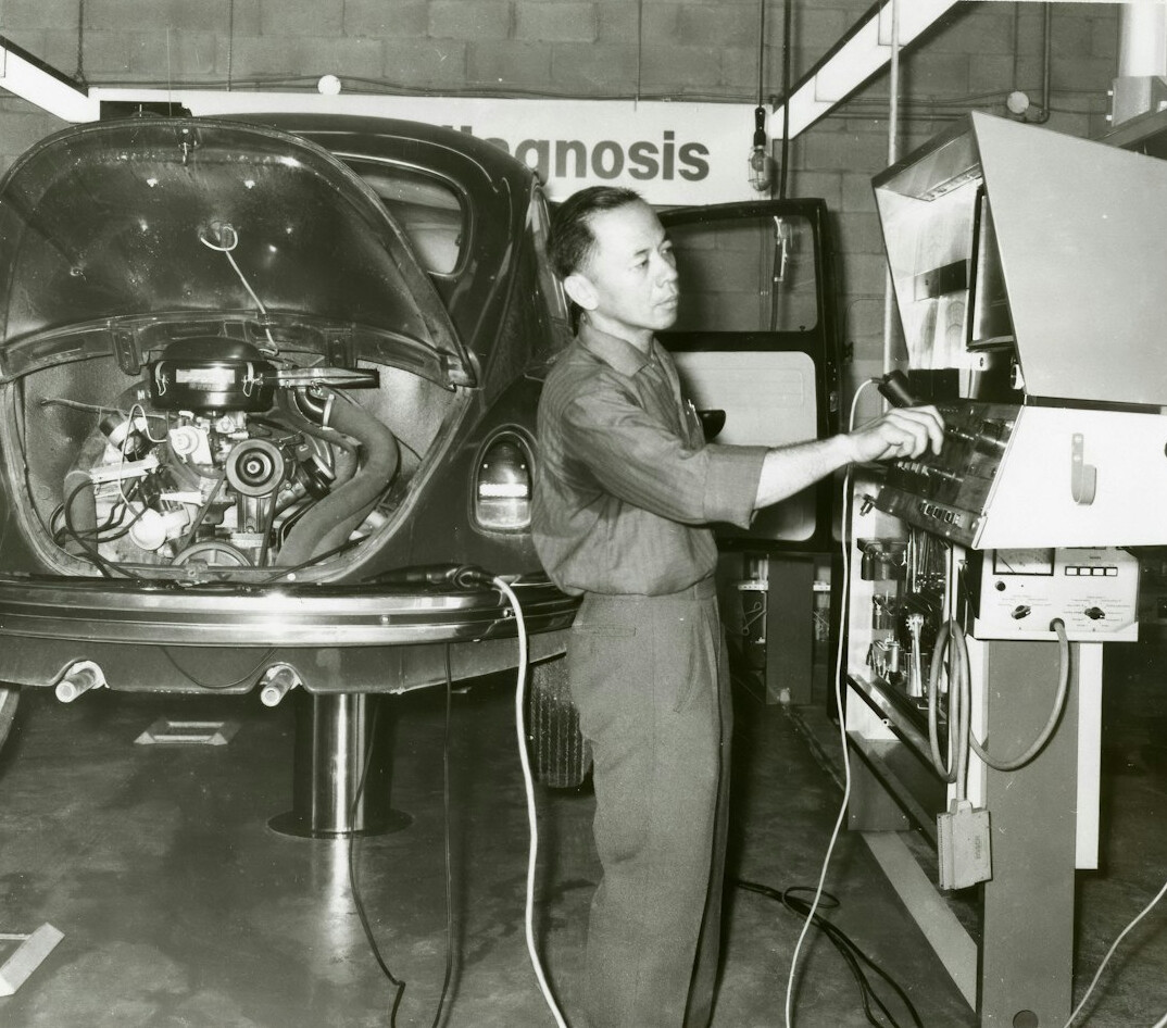 Editorial desk with vintage car photographs and documents spread out
