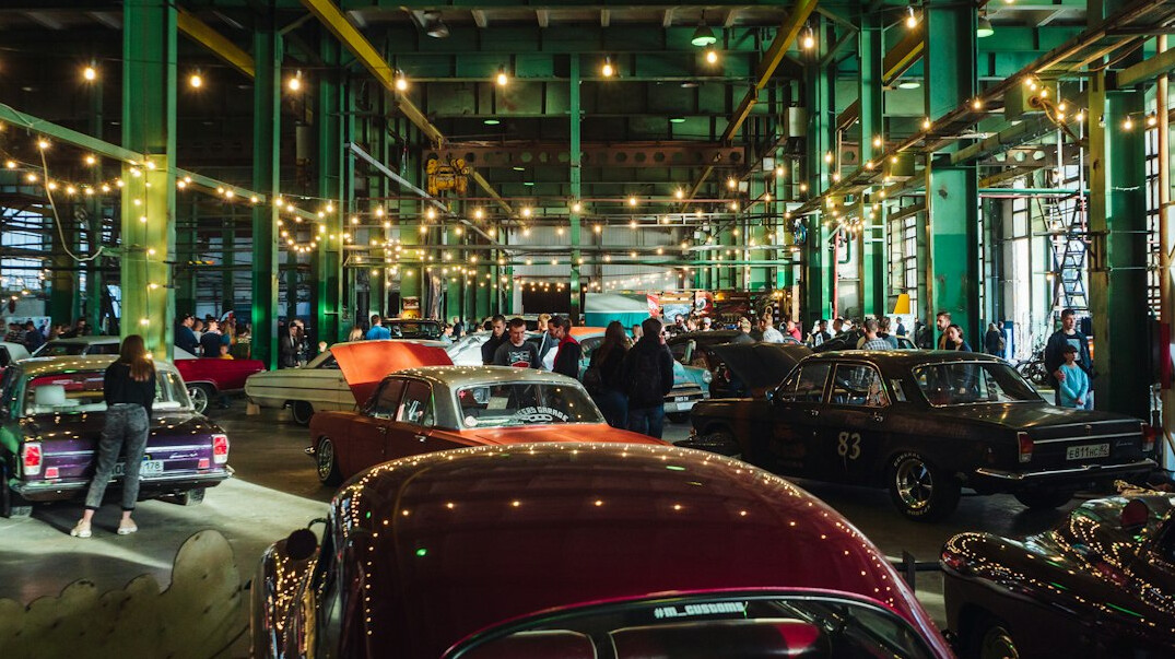 Crowd-free vintage car exhibition with rows of classic automobiles indoors
