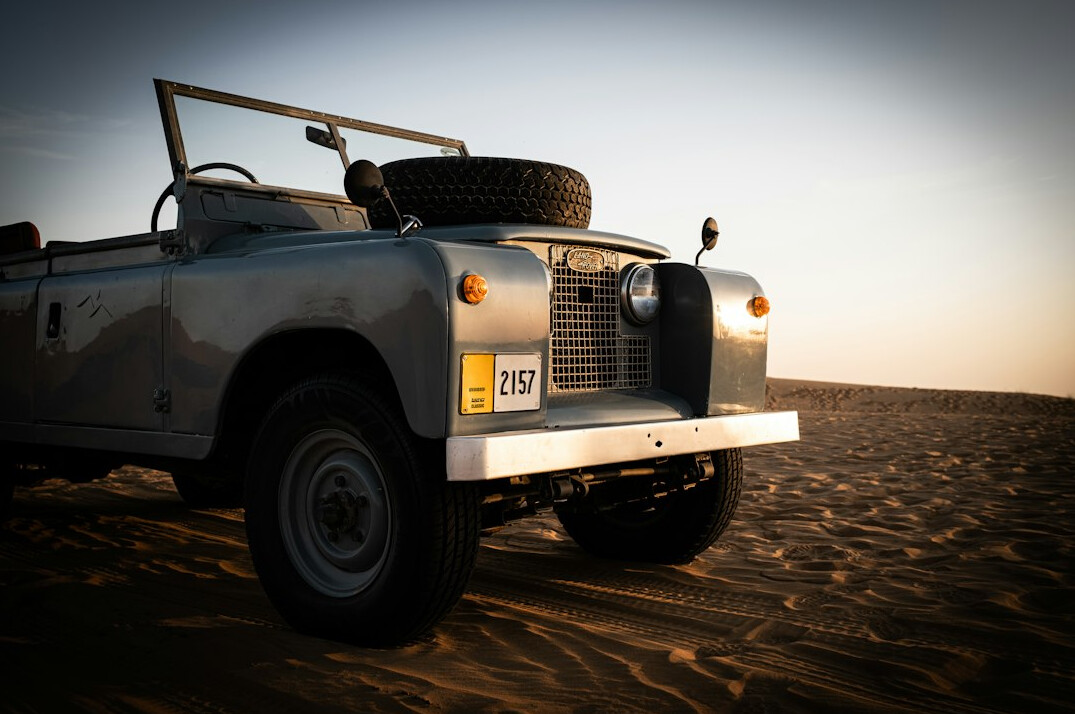Classic sports car parked on sand dunes near Jose Ignacio beach