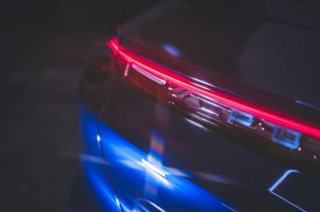 Futuristic electric performance car with glowing light details at night