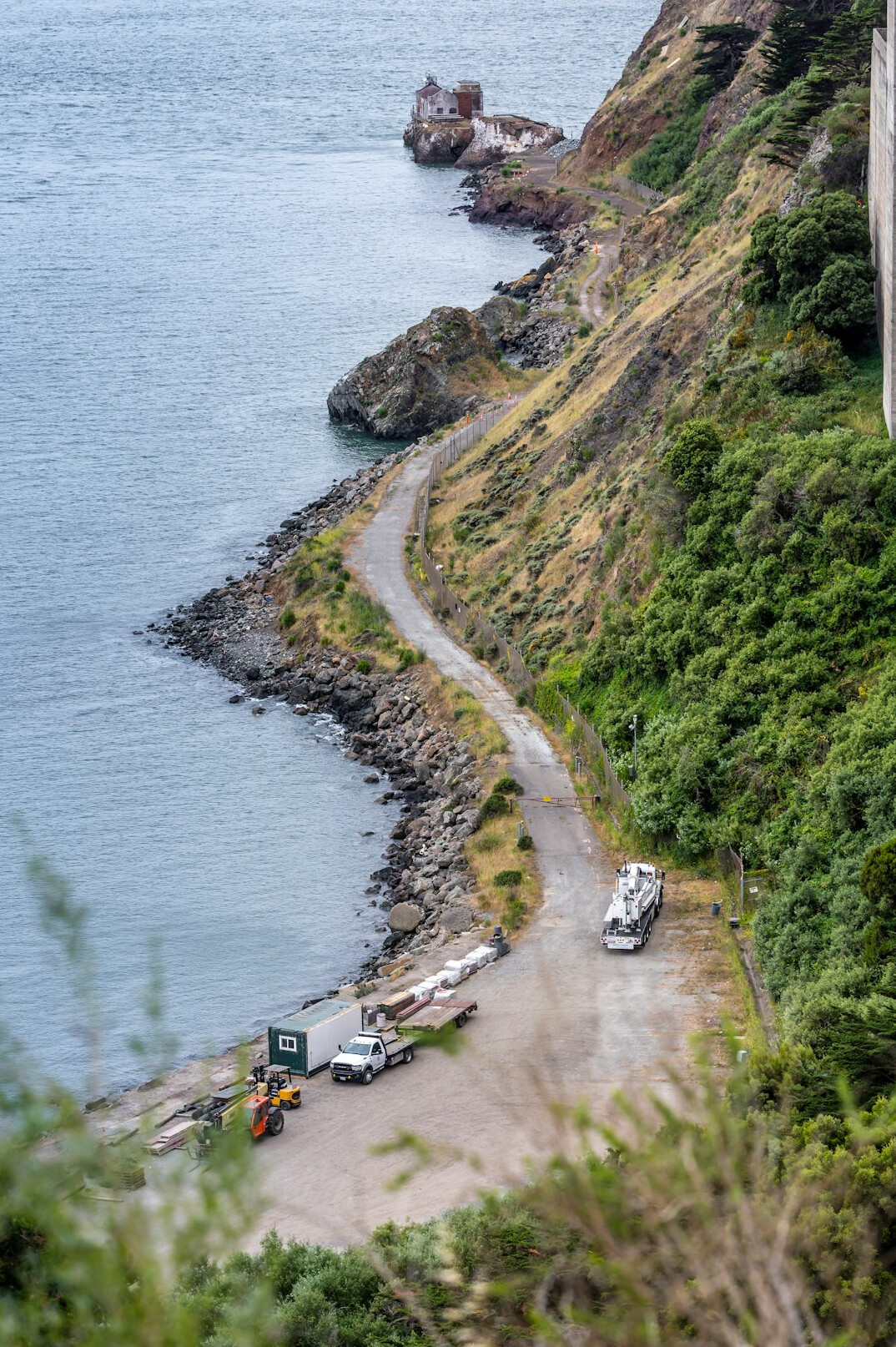 Classic rally cars parked along a coastal road overlooking the ocean in Maldonado
